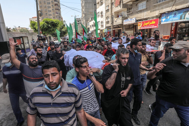 epa09190958 Palestinians mourners carry the bodies of Ameera Soboh and her son, Abed Soboh, during their funeral in the aftermath of Israel's retaliatory overnight air strike, in Al Shatea refugee camp in the west of Gaza City on 11 May 2021. Israel Defense Forces (IDF) said they hit over 100 Hamas targets in the Gaza Strip during a retaliatory overnight strike after rockets were fired at Israel by Palestinian militants.  EPA-EFE/MOHAMMED SABER