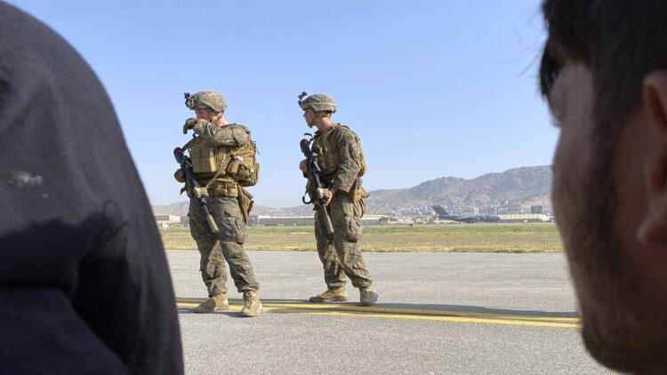 U.S soldiers stand guard along a perimeter at the international airport in Kabul, Afghanistan, Monday, Aug. 16, 2021. On Monday, the U.S. military and officials focus was on Kabul’s airport, where thousands of Afghans trapped by the sudden Taliban takeover rushed the tarmac and clung to U.S. military planes deployed to fly out staffers of the U.S. Embassy, which shut down Sunday, and others. (AP Photo/Shekib Rahmani)