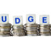 Stacks of coins with the word BUDGET isolated on white background