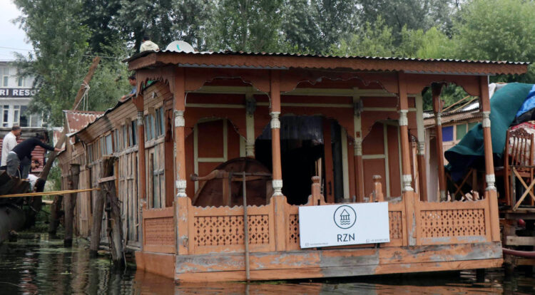 SRINAGAR, JUN 23 (UNI):- Seven tourists and two families were rescued when a deluxe houseboat capsized in the Dal Lake on Thursday. UNI PHOTO-71U