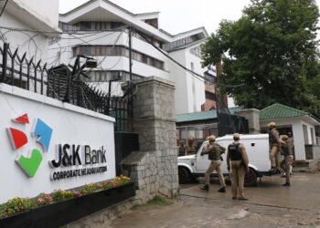 Srinagar: Security personnel outside the J&K Bank where raids by the state Anti-Corruption Bureau (ACB) are underway, in Srinagar on June 8, 2019. Within hours after the Jammu and Kashmir government sacked J&K Bank Chairman Parvez Ahmed, sleuths of ACB raided his office and residence in Srinagar. (Photo: IANS)